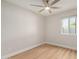 Bright bedroom featuring a ceiling fan, natural light from a window, and wood-look flooring at 2905 W Campo Bello Dr, Phoenix, AZ 85053