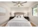 This bedroom features a ceiling fan, light wood floors, and small windows at 2905 W Campo Bello Dr, Phoenix, AZ 85053