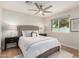 Bedroom features a ceiling fan, light wood floors, and bright light at 2905 W Campo Bello Dr, Phoenix, AZ 85053