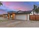 The single-story home features an attached garage, low maintenance yard, and unique architectural details at 2905 W Campo Bello Dr, Phoenix, AZ 85053