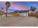 Exterior of single-story home featuring a two-car garage, modern front door, and xeriscaped yard at 2905 W Campo Bello Dr, Phoenix, AZ 85053