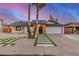 Charming single-story home featuring palm trees, a modern entrance, and a well-manicured front yard at 2905 W Campo Bello Dr, Phoenix, AZ 85053