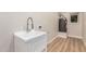 Functional laundry room featuring a utility sink, modern faucet, and water heater at 2905 W Campo Bello Dr, Phoenix, AZ 85053