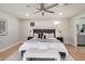 This bedroom features a ceiling fan, light wood floors, and small windows at 2905 W Campo Bello Dr, Phoenix, AZ 85053