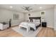 This bedroom features a ceiling fan, light wood floors, a gray rug and a chair at 2905 W Campo Bello Dr, Phoenix, AZ 85053