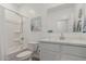 Bright bathroom with a shower/tub combination, toilet, and a vanity with white cabinets, and a decorative mirror at 2923 W Shanley Ave, Apache Junction, AZ 85120