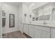 Bright bathroom featuring double sinks, white cabinetry, and decorative accents for a clean aesthetic at 2923 W Shanley Ave, Apache Junction, AZ 85120