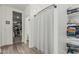 Bright bathroom featuring wood-style tile flooring, shower with curtain and built in shelving for organized living at 2923 W Shanley Ave, Apache Junction, AZ 85120