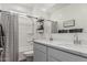 Stylish bathroom featuring a double vanity with white cabinets and modern fixtures, complemented by a shower with sleek accents at 2923 W Shanley Ave, Apache Junction, AZ 85120