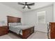 Neutral bedroom featuring a wood bedframe, ceiling fan, neutral walls and carpeted floors, offering a peaceful and relaxing retreat at 2923 W Shanley Ave, Apache Junction, AZ 85120