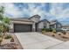 Inviting home features a spacious driveway and low maintenance landscaping, providing ample curb appeal at 2923 W Shanley Ave, Apache Junction, AZ 85120
