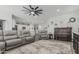 Relaxing living room with gray couches, a large ceiling fan, and wood-look tile flooring at 2923 W Shanley Ave, Apache Junction, AZ 85120
