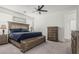 Comfortable main bedroom featuring neutral walls, carpet flooring, and a ceiling fan for optimal comfort at 2923 W Shanley Ave, Apache Junction, AZ 85120