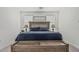 Well-lit main bedroom showcases a rustic wooden bed frame and decor for added warmth at 2923 W Shanley Ave, Apache Junction, AZ 85120