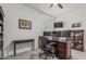 Well-lit office space featuring multiple monitors, a rolling chair, and carpeted floors, creating a productive work environment at 2923 W Shanley Ave, Apache Junction, AZ 85120