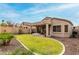 Backyard featuring a lush green lawn, covered patio, and mature landscaping at 3022 W Redwood Ln, Phoenix, AZ 85045