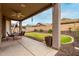 Covered backyard patio with ceiling fan and outdoor seating for entertaining at 3022 W Redwood Ln, Phoenix, AZ 85045