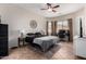 This bedroom features tile flooring, a ceiling fan, a workstation, and neutral wall colors at 3022 W Redwood Ln, Phoenix, AZ 85045