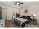 This bedroom features tile flooring, an ensuite bathroom, and neutral wall colors at 3022 W Redwood Ln, Phoenix, AZ 85045