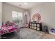 This bedroom features a rainbow tapestry, overhead lighting, and tile floors at 3022 W Redwood Ln, Phoenix, AZ 85045