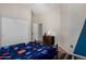 This bedroom has a blue accent wall and bedding, a ceiling fan, and tile flooring at 3022 W Redwood Ln, Phoenix, AZ 85045