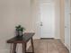 Bright entryway featuring tile flooring, neutral wall paint, and a decorative console table at 3022 W Redwood Ln, Phoenix, AZ 85045