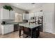 Bright kitchen features white cabinetry, stainless steel appliances, and a center island with seating at 3022 W Redwood Ln, Phoenix, AZ 85045