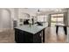 Open-concept area showcasing the kitchen and living room with natural light and modern features at 3022 W Redwood Ln, Phoenix, AZ 85045