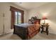 Comfortable bedroom with a large wooden bed frame, decorative bedding, and a bedside table at 3131 E Legacy Dr # 1057, Phoenix, AZ 85042
