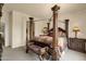 Comfortable bedroom featuring a decorative canopy bed, side table, and bench at 3131 E Legacy Dr # 1057, Phoenix, AZ 85042
