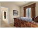 Relaxing bedroom featuring a patterned bedspread and an open doorway to a closet at 3131 E Legacy Dr # 1057, Phoenix, AZ 85042