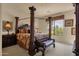 Comfortable bedroom featuring a decorative canopy bed, side table, and window view at 3131 E Legacy Dr # 1057, Phoenix, AZ 85042