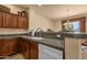 Well-lit kitchen with granite counters, wooden cabinetry and modern white appliances at 3131 E Legacy Dr # 1057, Phoenix, AZ 85042