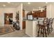 Open kitchen area with breakfast bar and tile flooring with office area in background at 3131 E Legacy Dr # 1057, Phoenix, AZ 85042