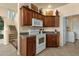 Well-lit kitchen featuring granite counters, wooden cabinetry and modern appliances at 3131 E Legacy Dr # 1057, Phoenix, AZ 85042