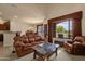 Comfortable living room flowing into dining area with golf course views at 3131 E Legacy Dr # 1057, Phoenix, AZ 85042