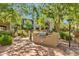 Outdoor kitchen area with built-in grill surrounded by lush landscaping and mature trees at 3131 E Legacy Dr # 1057, Phoenix, AZ 85042