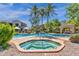 Inviting community pool and spa area with lush landscaping and several palm trees at 3131 E Legacy Dr # 1057, Phoenix, AZ 85042
