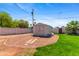 Enclosed backyard featuring a storage shed, complemented by gravel and grassy areas at 3243 E Sheridan St, Phoenix, AZ 85008