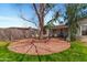 Beautifully landscaped backyard with a brick patio and mature trees providing ample shade at 3243 E Sheridan St, Phoenix, AZ 85008