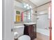 Bright bathroom featuring a vanity, framed mirror, and shower-tub combo at 3243 E Sheridan St, Phoenix, AZ 85008