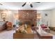A cozy living room featuring a fireplace, comfortable sofa, and plenty of natural light at 3243 E Sheridan St, Phoenix, AZ 85008