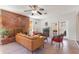 Bright living room with natural light, a brick fireplace, and stylish furnishings at 3243 E Sheridan St, Phoenix, AZ 85008