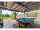 Covered outdoor patio with a pool table, perfect for entertaining guests and enjoying the outdoors at 3243 E Sheridan St, Phoenix, AZ 85008