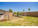 Backyard featuring green grass, palm trees, and a dog run at 34949 N Spur Cir, San Tan Valley, AZ 85144