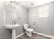 Neutral half bath with pedestal sink and modern fixtures and natural light at 34949 N Spur Cir, San Tan Valley, AZ 85144