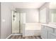 Bathroom with a glass-enclosed shower, soaking tub, and a dual-sink vanity with cabinets at 34949 N Spur Cir, San Tan Valley, AZ 85144