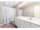 Bathroom featuring double sinks, a large mirror, and a tiled floor at 34949 N Spur Cir, San Tan Valley, AZ 85144