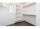 Walk-in closet featuring shelving and hanging rods for optimal storage and a window at 34949 N Spur Cir, San Tan Valley, AZ 85144