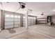 Three car garage with epoxy flooring and storage shelves at 34949 N Spur Cir, San Tan Valley, AZ 85144